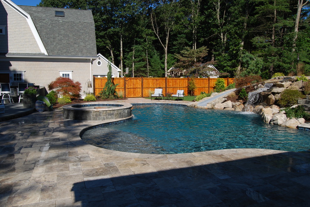 Example of a mid-sized mountain style backyard stone and kidney-shaped natural water slide design in Boston