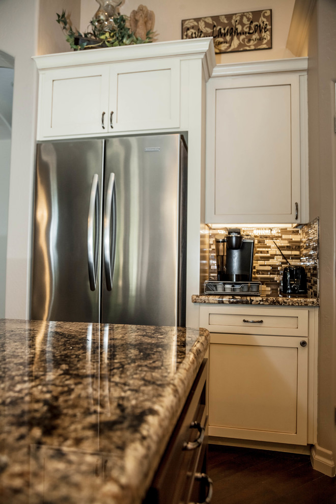 Large transitional l-shaped dark wood floor eat-in kitchen photo in Phoenix with an undermount sink, recessed-panel cabinets, white cabinets, granite countertops, multicolored backsplash, glass tile backsplash, stainless steel appliances and an island
