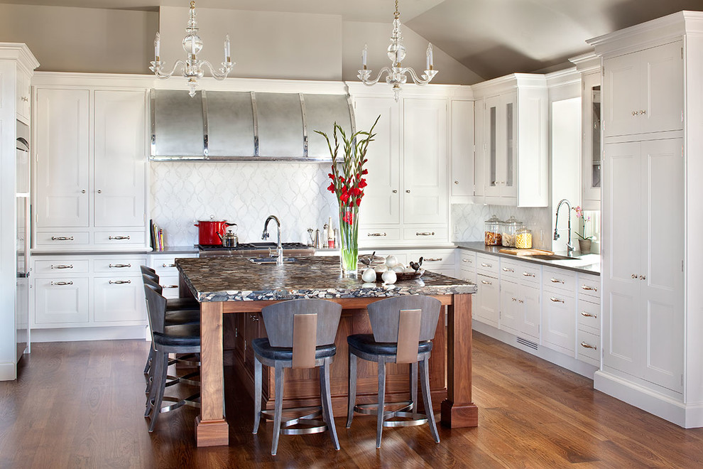 Open concept kitchen - large transitional u-shaped medium tone wood floor open concept kitchen idea in Denver with recessed-panel cabinets, white cabinets, white backsplash, an island, an undermount sink, quartz countertops, stone tile backsplash and stainless steel appliances