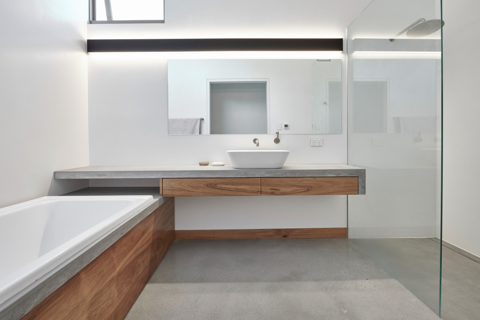 Design ideas for a small contemporary master bathroom in Perth with medium wood cabinets, a drop-in tub, an open shower, white tile, white walls, concrete floors, a vessel sink, concrete benchtops, grey floor, an open shower and grey benchtops.