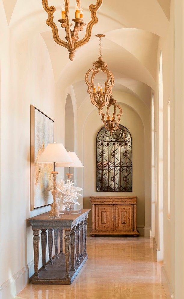 Design ideas for a mid-sized mediterranean hallway in Dallas with white walls and travertine floors.