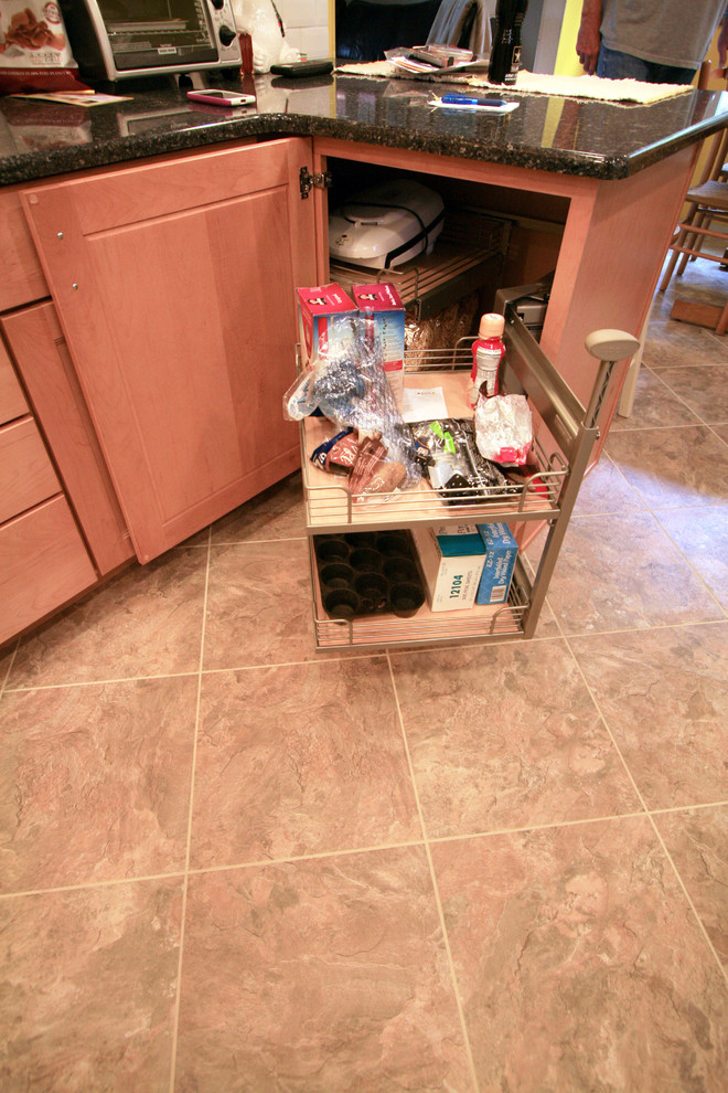 Eat-in kitchen - small transitional eat-in kitchen idea with an undermount sink, recessed-panel cabinets, light wood cabinets, quartz countertops, white backsplash, subway tile backsplash, white appliances and a peninsula