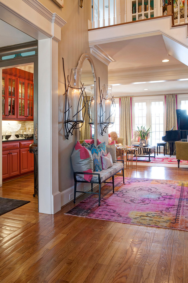 Photo of a large eclectic foyer in Other with beige walls and medium hardwood floors.