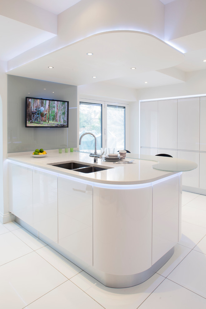 Inspiration for a mid-sized contemporary u-shaped eat-in kitchen in Other with a double-bowl sink, flat-panel cabinets, white cabinets, recycled glass benchtops, white splashback, glass sheet splashback, ceramic floors and with island.