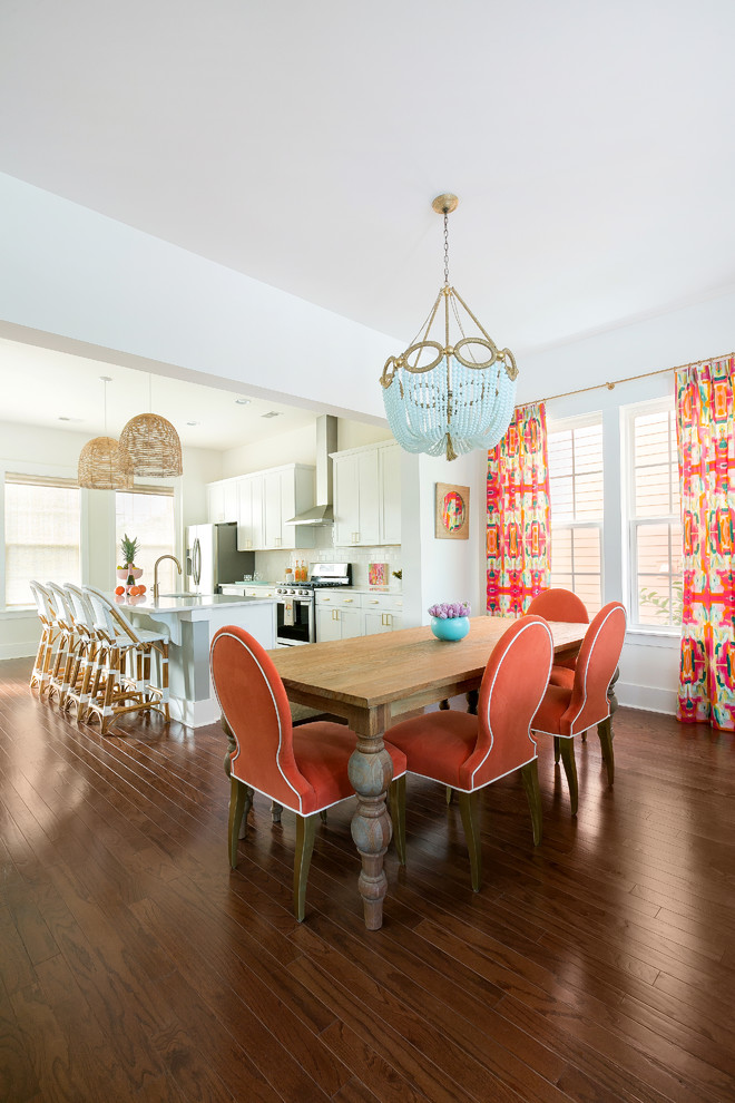 Tropical kitchen/dining combo in Charleston with white walls, dark hardwood floors and brown floor.