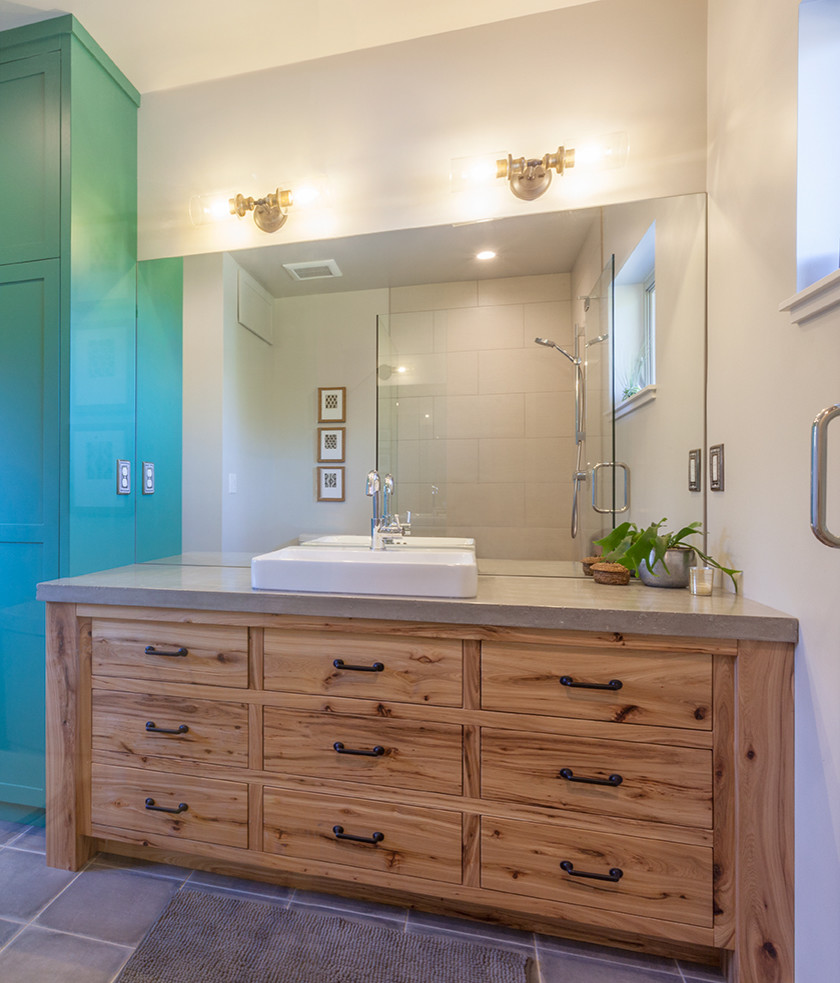 Transitional bathroom photo with furniture-like cabinets, medium tone wood cabinets, a vessel sink and concrete countertops