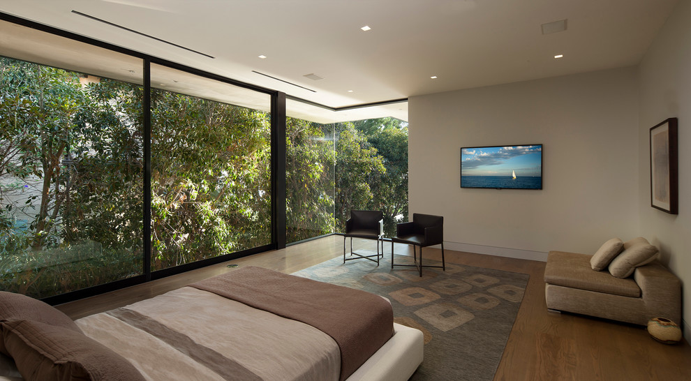 Modern bedroom in Los Angeles with medium hardwood floors.