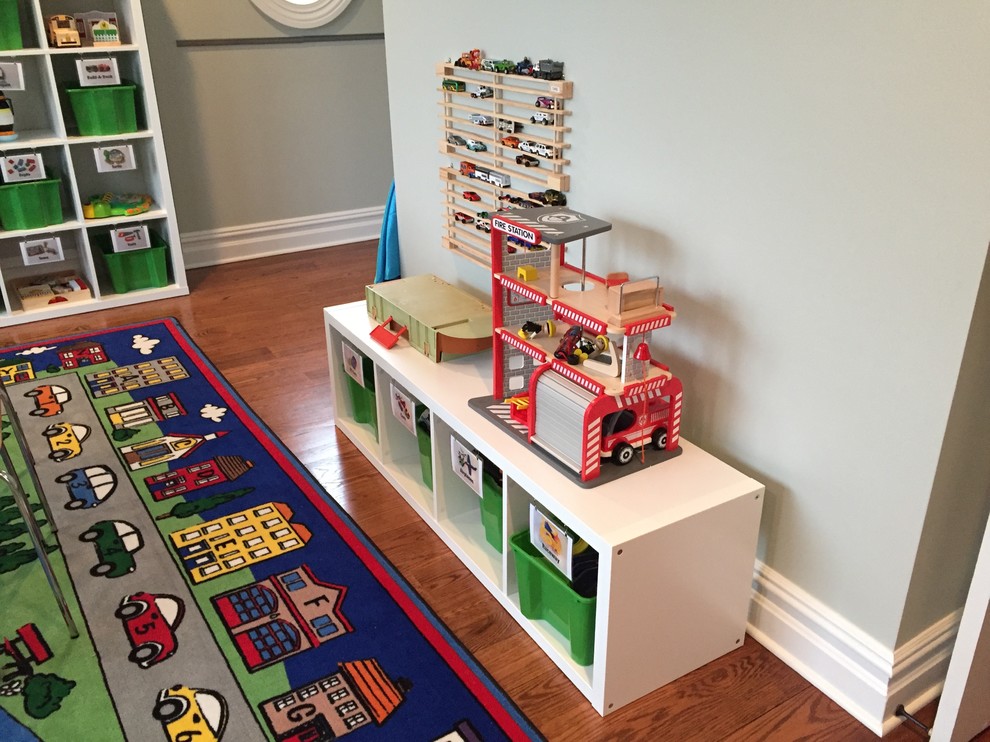 Mid-sized transitional gender-neutral kids' playroom in New York with beige walls, medium hardwood floors and brown floor for kids 4-10 years old.
