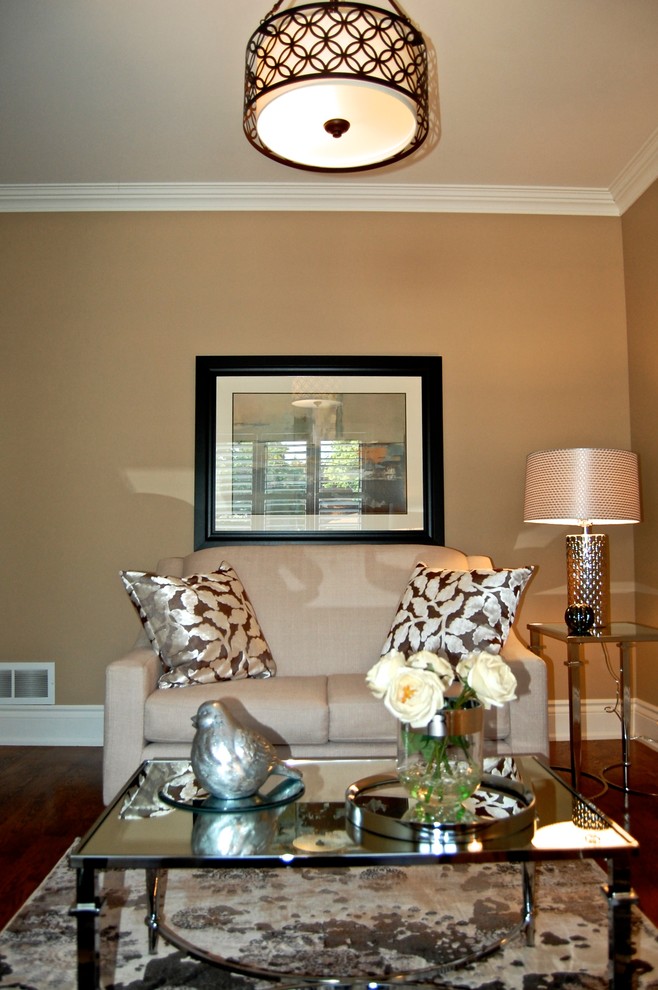 Photo of a mid-sized transitional enclosed living room in Toronto with beige walls and medium hardwood floors.