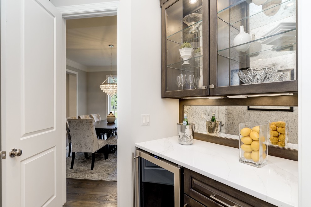 Open concept kitchen - large transitional u-shaped light wood floor and beige floor open concept kitchen idea in DC Metro with an undermount sink, raised-panel cabinets, white cabinets, quartzite countertops, white backsplash, subway tile backsplash, stainless steel appliances and an island