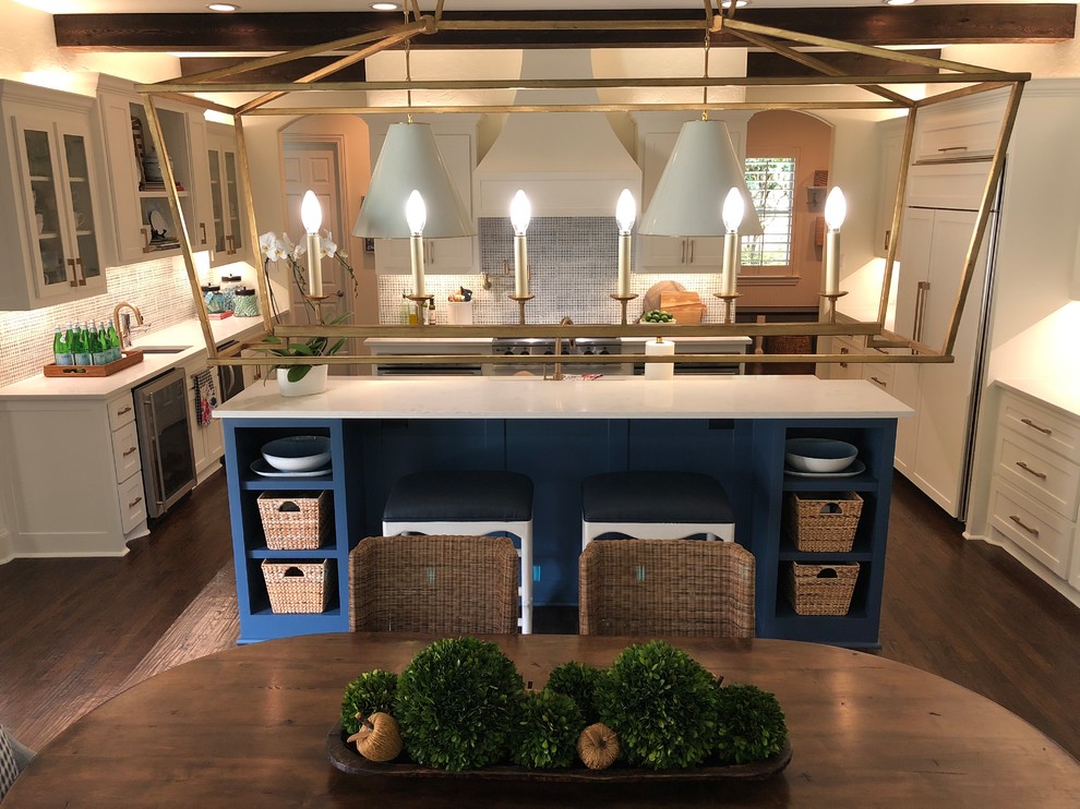 This is an example of a large transitional u-shaped eat-in kitchen in Dallas with an undermount sink, shaker cabinets, blue cabinets, quartz benchtops, blue splashback, porcelain splashback, stainless steel appliances, dark hardwood floors, with island, brown floor and white benchtop.