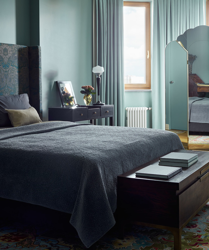 Inspiration for a transitional master bedroom with blue walls, medium hardwood floors and brown floor.