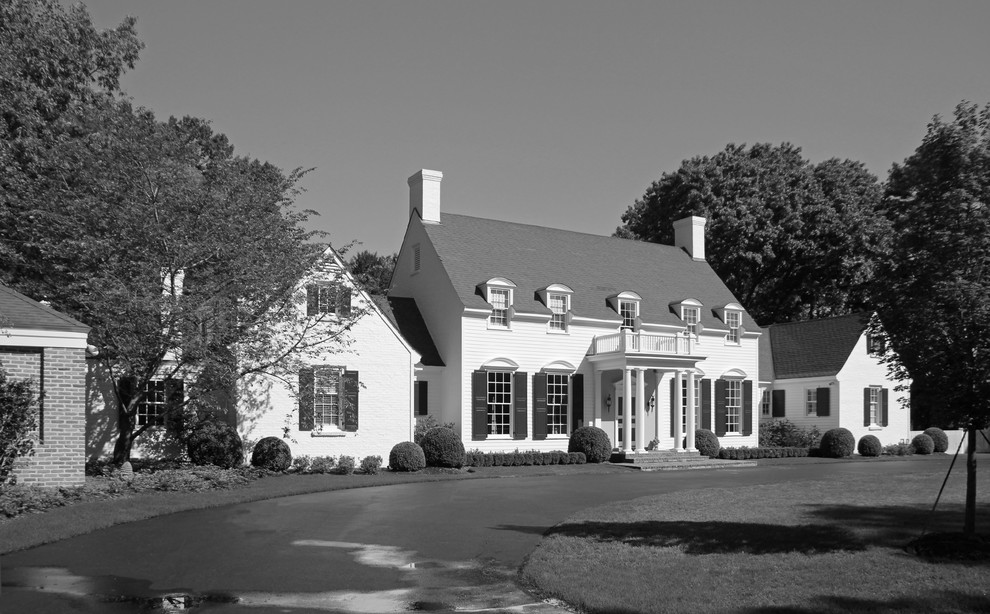 Large traditional two-storey white house exterior in Other with vinyl siding, a gable roof and a shingle roof.