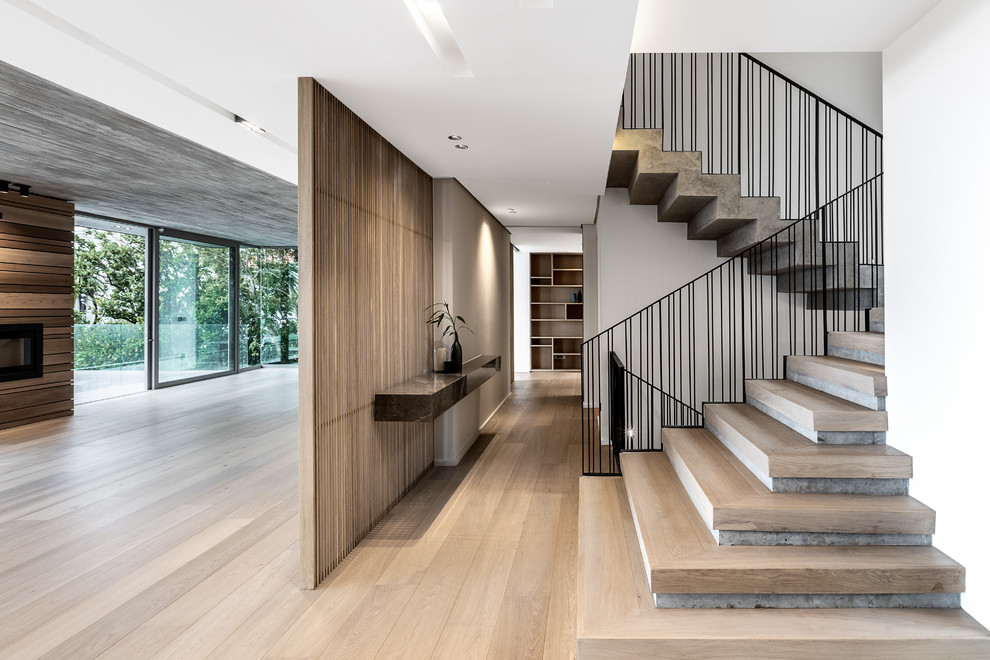 Inspiration for a contemporary wood u-shaped staircase in Other with metal railing.