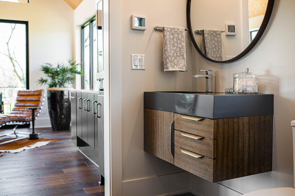 This is an example of a medium sized scandi cloakroom in Indianapolis with flat-panel cabinets, medium wood cabinets, medium hardwood flooring, a submerged sink and a built in vanity unit.