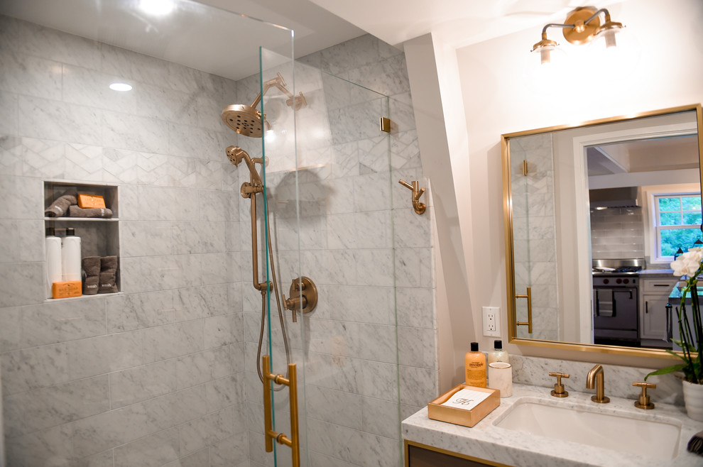 This is an example of a small transitional 3/4 bathroom in San Francisco with furniture-like cabinets, grey cabinets, an alcove shower, a two-piece toilet, white tile, marble, white walls, marble floors, an undermount sink, marble benchtops, white floor, a hinged shower door, white benchtops, a niche, a single vanity, a freestanding vanity and vaulted.