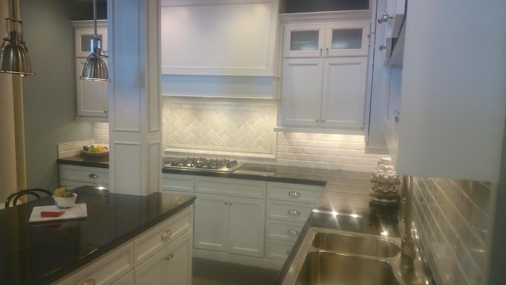 Inspiration for a mid-sized transitional l-shaped eat-in kitchen remodel in Baltimore with a double-bowl sink, white cabinets, white backsplash, stainless steel appliances, an island, recessed-panel cabinets, quartz countertops and ceramic backsplash