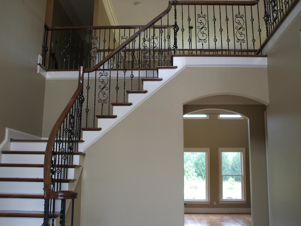 Photo of a large traditional wood l-shaped staircase in Atlanta with painted wood risers.