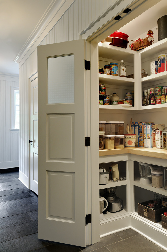 Photo of a traditional kitchen pantry in New York with open cabinets and white cabinets.