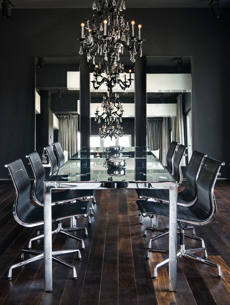 Inspiration for a contemporary separate dining room in London with dark hardwood floors and black walls.