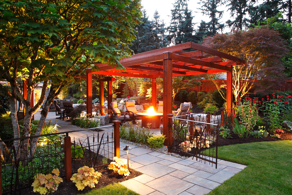 This is an example of a front yard verandah in Seattle with a water feature, brick pavers and a roof extension.