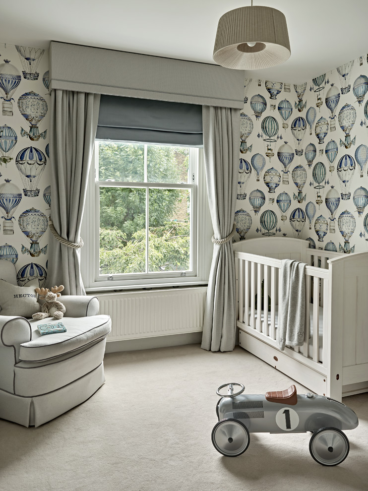 Photo of a mid-sized transitional nursery for boys in London with carpet, multi-coloured walls and beige floor.
