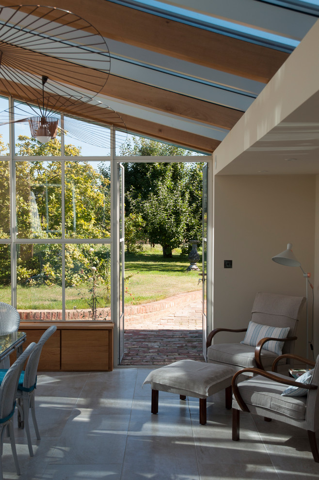 This is an example of a mid-sized contemporary sunroom in Kent with a glass ceiling.