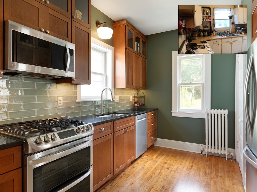 Inspiration for a small traditional galley separate kitchen in Minneapolis with an undermount sink, shaker cabinets, medium wood cabinets, granite benchtops, green splashback, ceramic splashback, stainless steel appliances, light hardwood floors, brown floor and black benchtop.