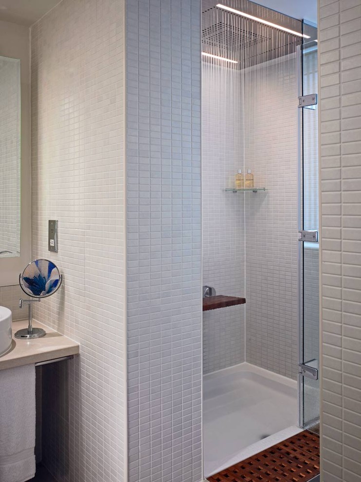 Photo of a modern bathroom in London with an alcove shower and gray tile.