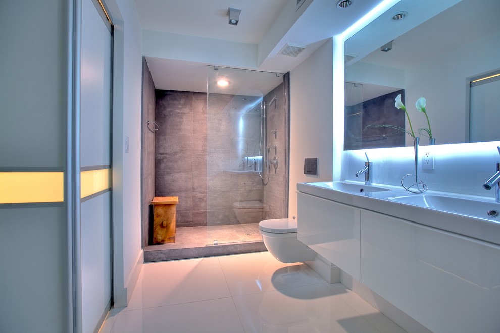 Contemporary bathroom in Kansas City with porcelain tile and a wall-mount toilet.