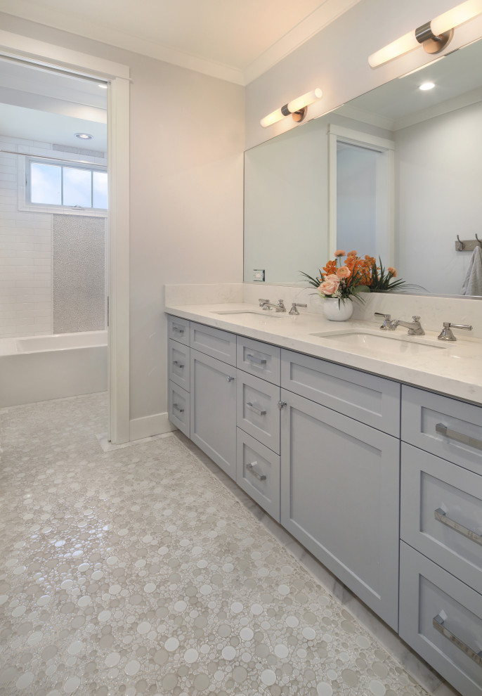 Photo of a mid-sized transitional kids bathroom in Orange County with shaker cabinets, grey cabinets, an undermount tub, an alcove shower, grey walls, mosaic tile floors, an undermount sink, engineered quartz benchtops, white floor, a hinged shower door, white benchtops, a double vanity and a built-in vanity.