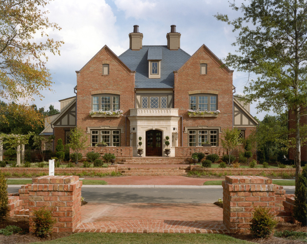 This is an example of a large traditional three-storey brick exterior in Charlotte.