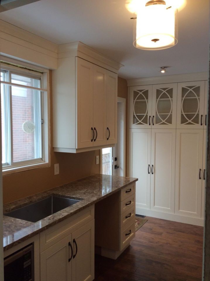 Kitchen - mid-sized transitional medium tone wood floor kitchen idea in Toronto with an undermount sink, recessed-panel cabinets, white cabinets and granite countertops