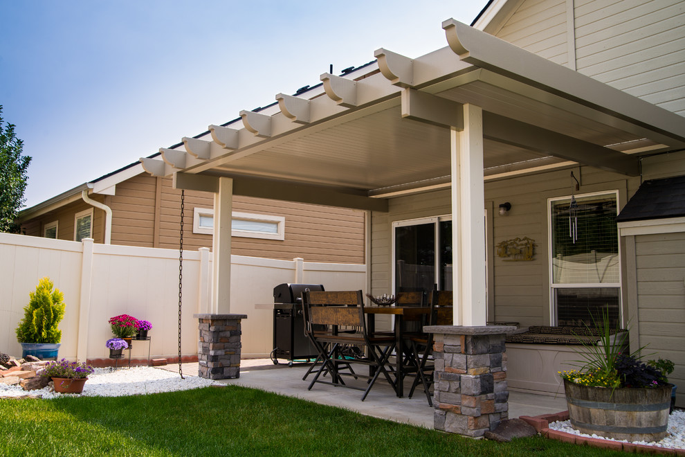 Large modern backyard patio in Boise with an awning.