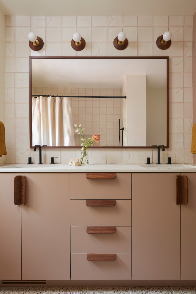 This is an example of a mid-sized midcentury kids bathroom in San Francisco with flat-panel cabinets, brown cabinets, an alcove tub, a shower/bathtub combo, a one-piece toilet, white tile, ceramic tile, white walls, terrazzo floors, an undermount sink, engineered quartz benchtops, brown floor, a shower curtain, grey benchtops, a niche, a double vanity and a built-in vanity.