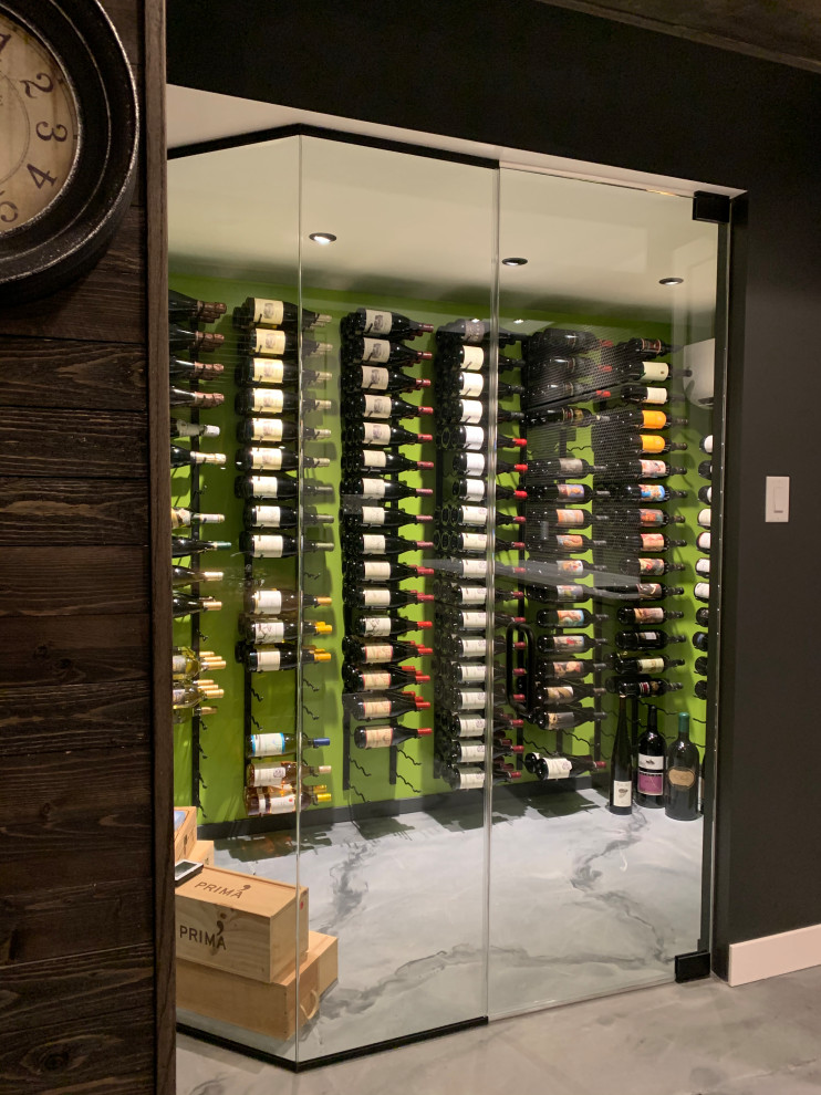 Inspiration for a small eclectic wine cellar in Cincinnati with concrete floors, display racks and grey floor.