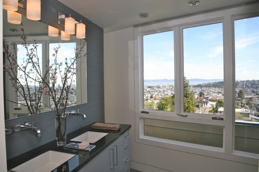This is an example of a contemporary bathroom in San Francisco with an undermount sink, flat-panel cabinets and grey cabinets.