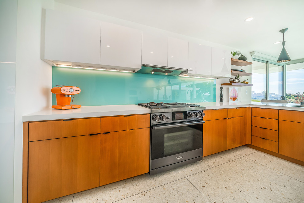 Inspiration for a mid-sized contemporary l-shaped eat-in kitchen in Los Angeles with an undermount sink, flat-panel cabinets, white cabinets, quartz benchtops, blue splashback, glass sheet splashback, stainless steel appliances, terrazzo floors, a peninsula, grey floor and white benchtop.