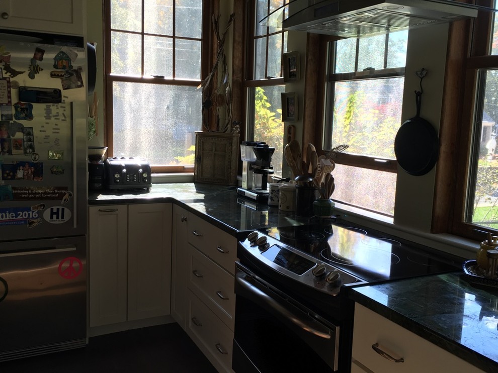 Transitional u-shaped dark wood floor kitchen photo in Boston with an undermount sink, shaker cabinets, white cabinets, granite countertops and stainless steel appliances