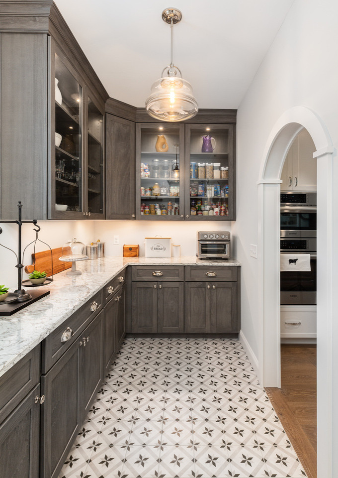 Photo of an expansive classic l-shaped kitchen pantry in Boston with grey cabinets, engineered stone countertops, white worktops and recessed-panel cabinets.