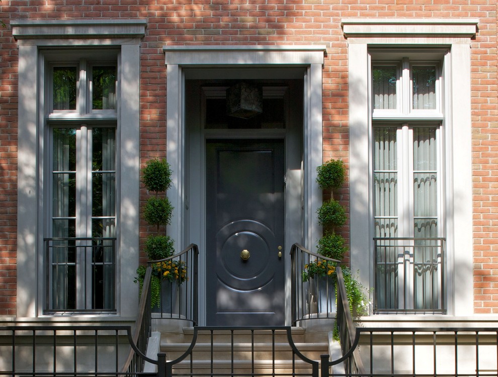 This is an example of a traditional front door in Chicago with a single front door and a gray front door.