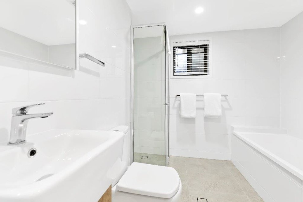 Photo of a mid-sized contemporary bathroom in Sunshine Coast with white walls, porcelain floors and grey floor.