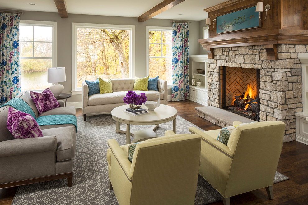 This is an example of a large transitional formal open concept living room in Minneapolis with grey walls, dark hardwood floors, a standard fireplace, a stone fireplace surround and no tv.