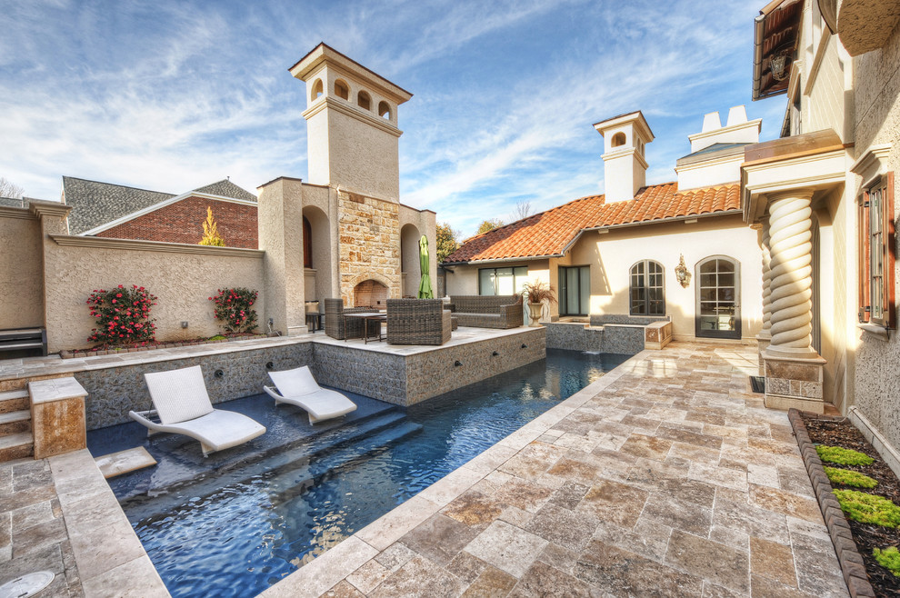 Photo of a mid-sized mediterranean courtyard custom-shaped lap pool in Charlotte with a hot tub and natural stone pavers.