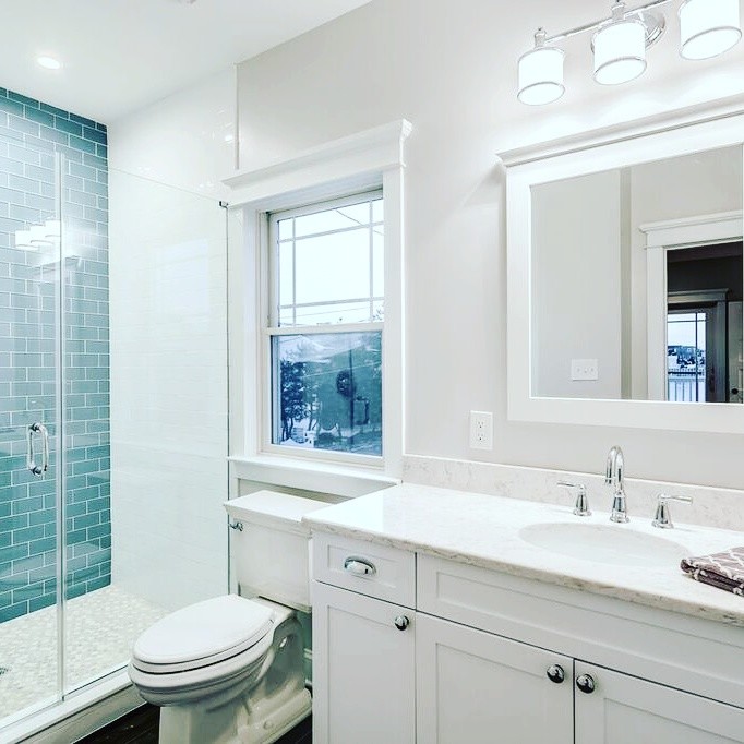 Mid-sized beach style kids bathroom in Philadelphia with shaker cabinets, white cabinets, a double shower, a two-piece toilet, blue tile, subway tile, grey walls, ceramic floors, an undermount sink and quartzite benchtops.