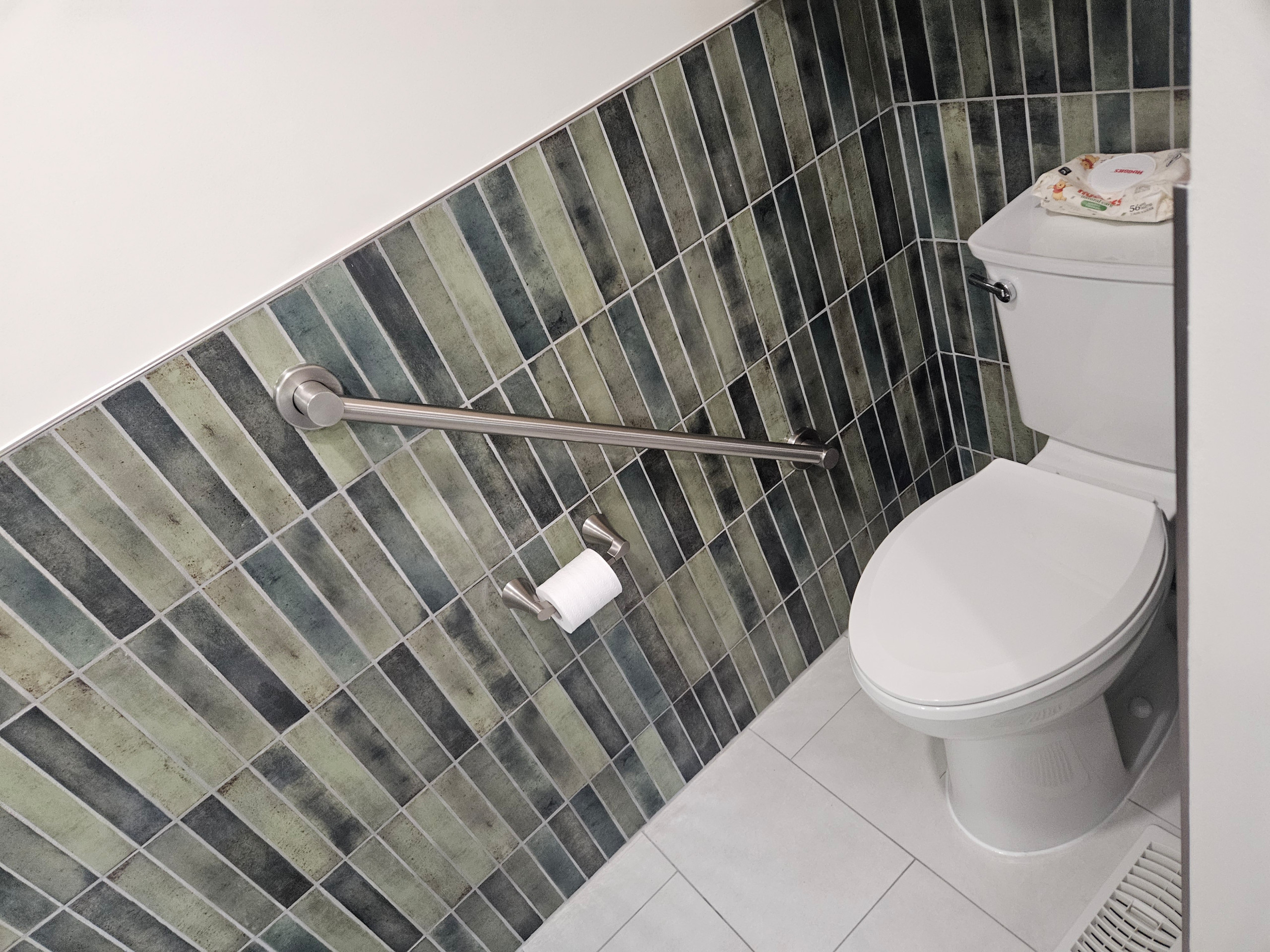 New toilet, flooring, grab bar, tile and paintjob.