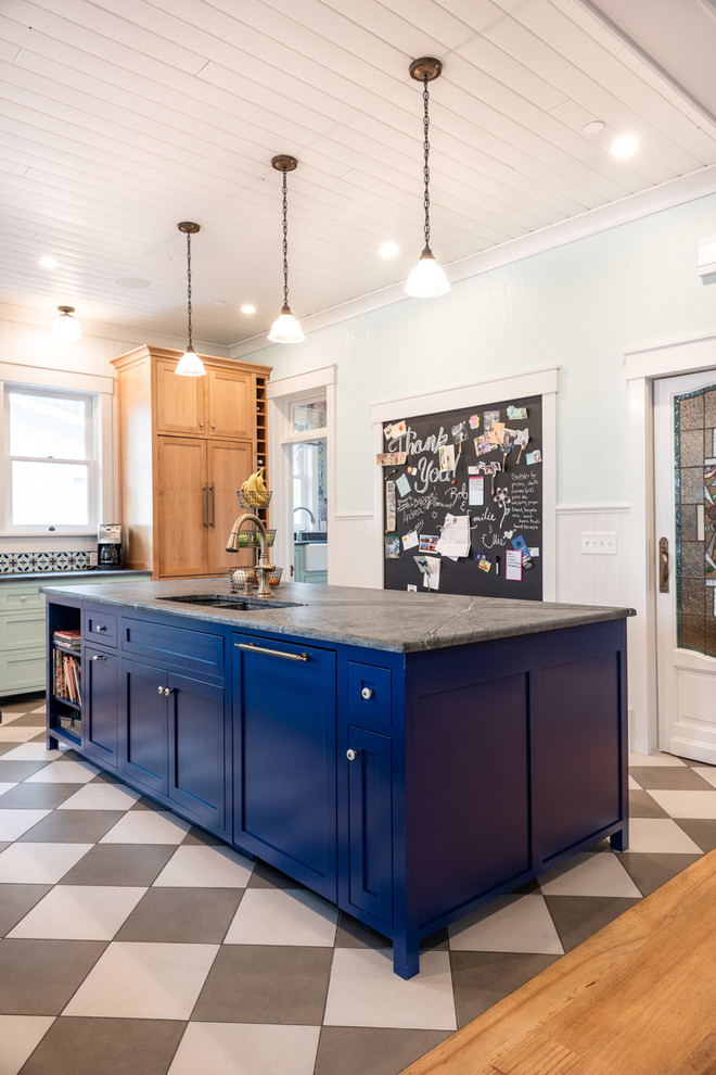 Photo of a large eclectic u-shaped eat-in kitchen in San Luis Obispo with a double-bowl sink, shaker cabinets, blue cabinets, multi-coloured splashback, brick splashback, porcelain floors, multiple islands, multi-coloured floor and grey benchtop.