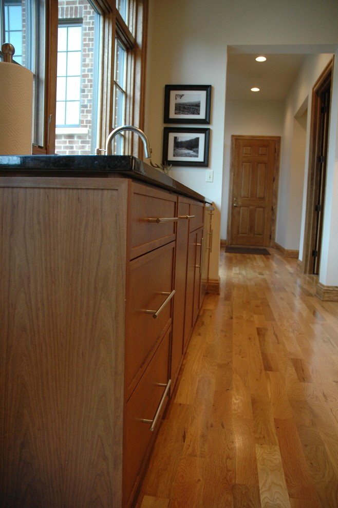 Inspiration for a transitional u-shaped eat-in kitchen remodel with an undermount sink, flat-panel cabinets, laminate countertops, white backsplash and stainless steel appliances