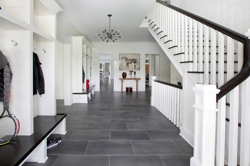 Inspiration for a mid-sized transitional hallway in New York with white walls and slate floors.