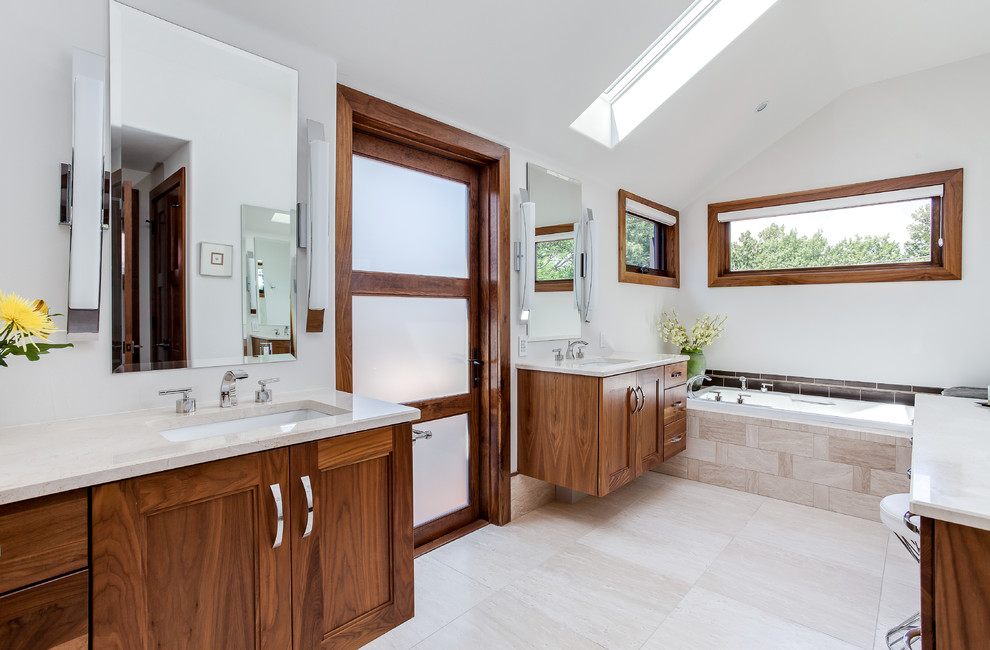 This is an example of a large contemporary master bathroom in Denver with recessed-panel cabinets, medium wood cabinets, an alcove tub, gray tile, porcelain tile, white walls, an undermount sink, engineered quartz benchtops and an alcove shower.